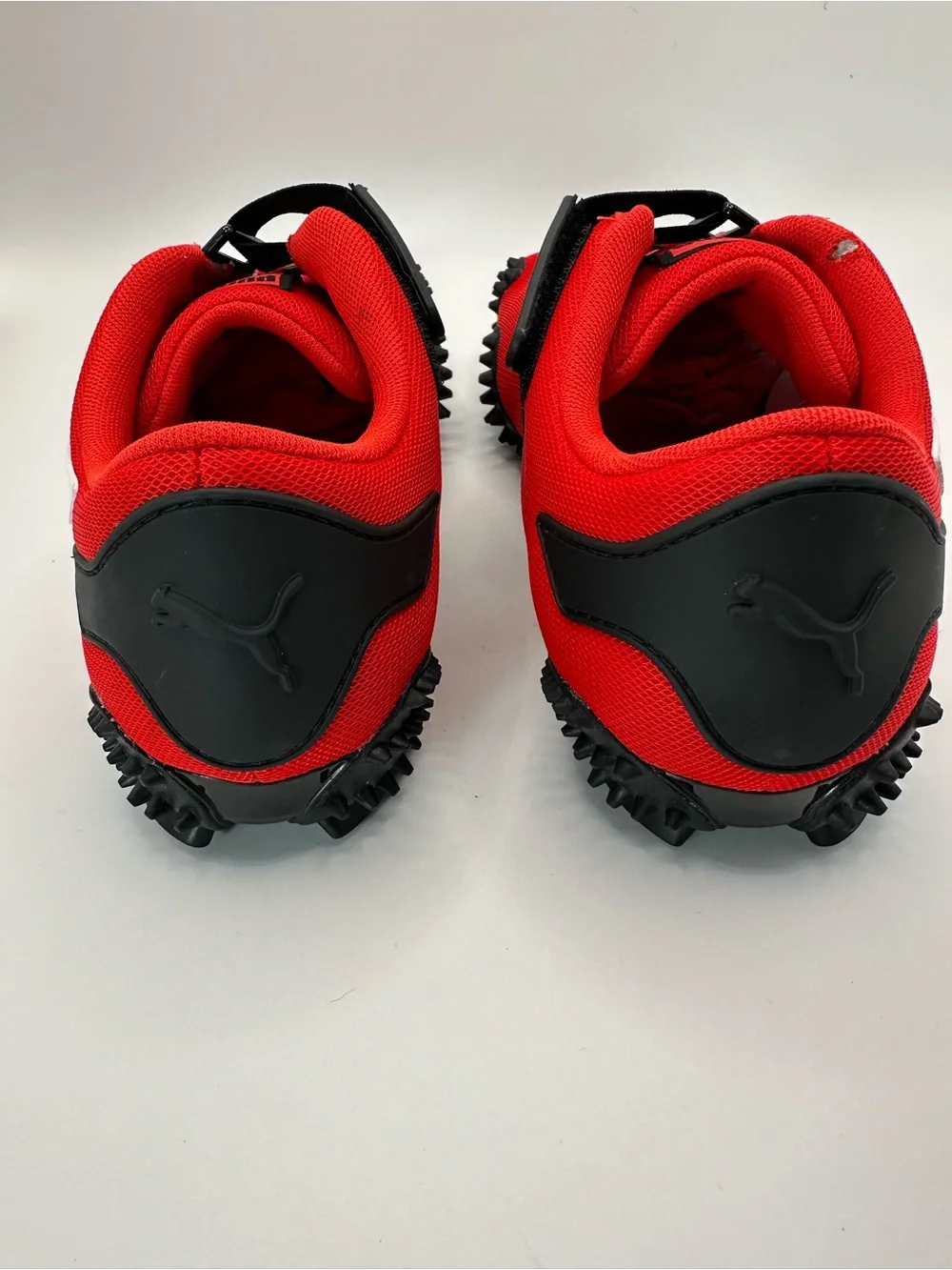 Puma Red and White Spike-Style Athletic Sneakers visible defects